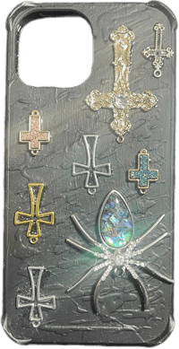 a phone case with a cross and other symbols on it