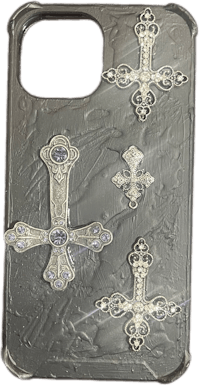 a silver phone case with a cross on it